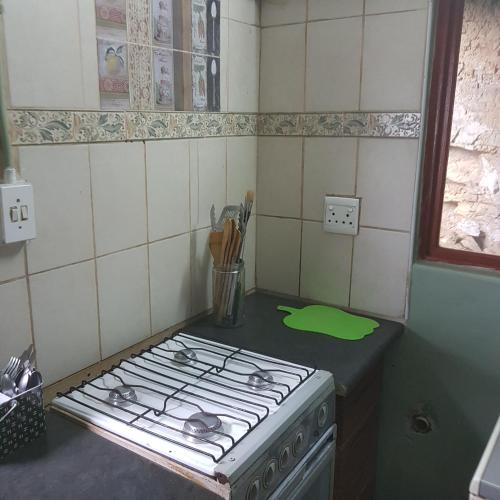 a kitchen with a stove top oven in a kitchen at Fishermen s Cave in Port St Johns