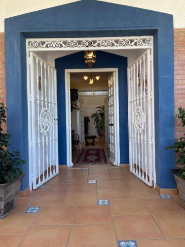 a hallway with blue walls and white doors at Anna's garden in Torrevieja