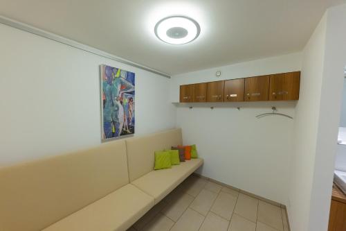 a kitchen with a bench and a painting on the wall at Boardinghouse HOME - adults only - in Konstanz