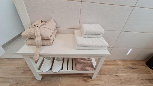 a white table with towels on it in a bathroom at Alex's Desert Place in Beʼer Ora