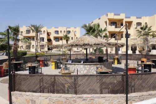 a resort with a bar in front of a building at Blend Elphistone Resort Marsa Alam in Abu Dabab