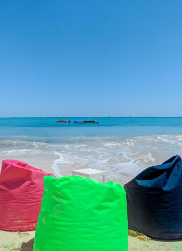 a group of colorful beach towels on the beach at Jewel Matrouh Hotel in Marsa Matruh