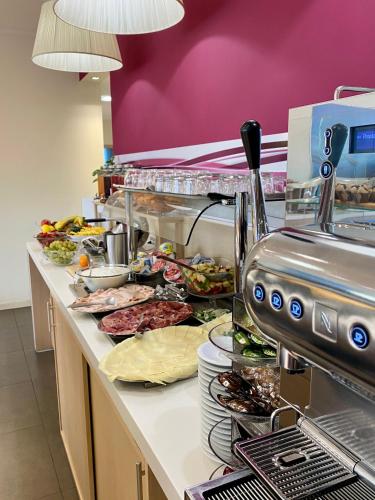 a buffet line with many different types of food at Best Western Palace Inn Hotel in Ferrara