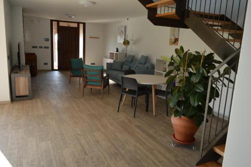 a living room with a couch and a table and chairs at Mas Piua in Girona