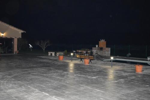 a patio at night with a table and lights at Mas Piua in Girona