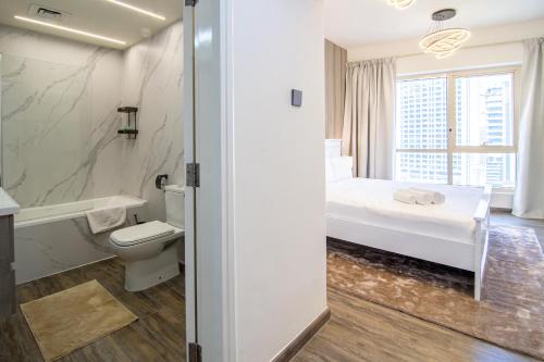 a bathroom with a bed and a toilet and a sink at Veluxa - Large and Stylish 1 Bed in JLT! in Dubai