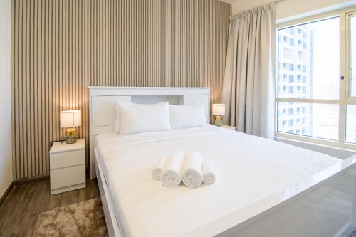 a hotel room with a bed with two towels on it at Veluxa - Large and Stylish 1 Bed in JLT! in Dubai