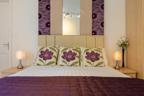 a bedroom with a large bed with two lamps at The Richmond Bed and Breakfast - Adults only in Shanklin