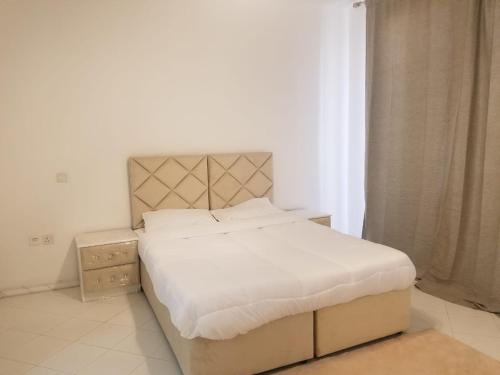 a bedroom with a large bed with white sheets at Spacious 3BR Townhouse Villa in Dubai