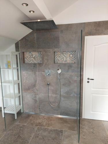 a bathroom with a shower with a glass door at Ferienhaus Landsberg in Landsberg am Lech