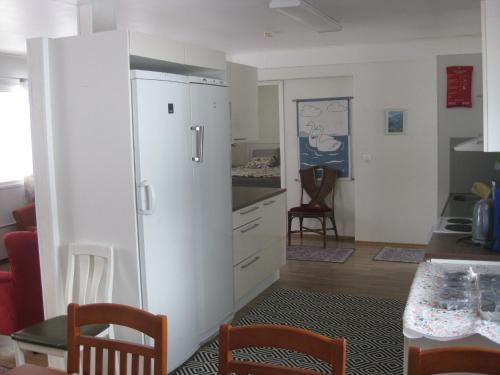 a kitchen with a white refrigerator in a room at Huoneistomajoitus Hella 3C Härmä in Härmä