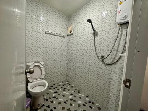 a bathroom with a toilet and a shower at Kalae Resort in Ban Nong Ben