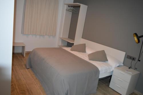 a bedroom with a bed with two pillows on it at Mas Piua in Girona