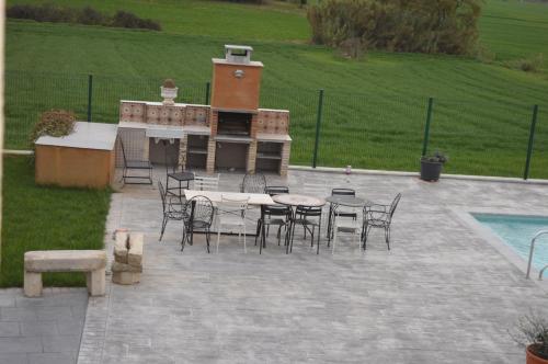 a patio with a table and chairs and a barbecue at Mas Piua in Girona