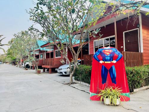 a superman cape is sitting outside of a house at Kalae Resort in Ban Nong Ben