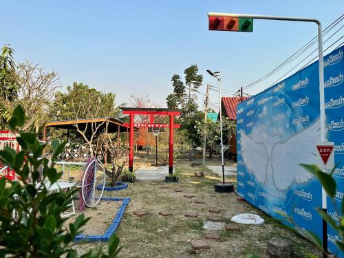 a bus stop with a red structure and a street light at Kalae Resort in Ban Nong Ben