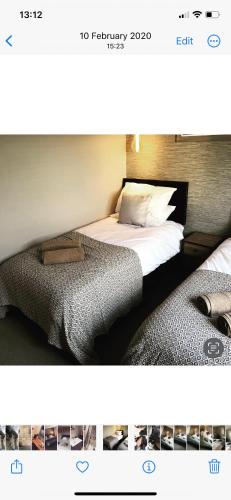 two beds sitting next to each other in a bedroom at The Station Restaurant & Bar in Doncaster