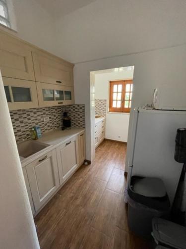 a kitchen with white cabinets and a white refrigerator at Villa Connie in Serranova