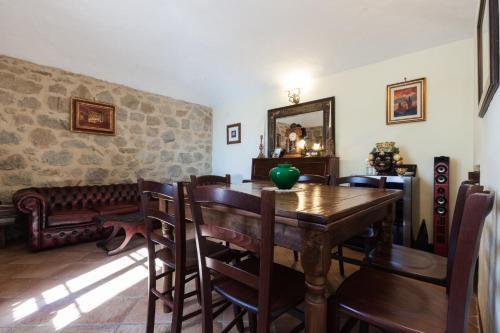 a dining room with a table and chairs and a mirror at Borgo Tepolini Country House in Castel del Piano