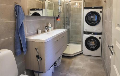 a bathroom with a sink and a washing machine at Nice Home In Rde With 2 Bedrooms in Råde