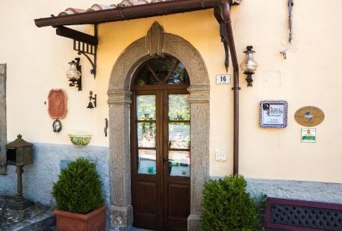 an entrance to a building with a wooden door at Borgo Tepolini Country House in Castel del Piano