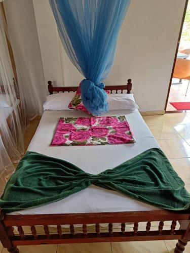 a bed with a green dress on top of it at The blue sky in Ahangama