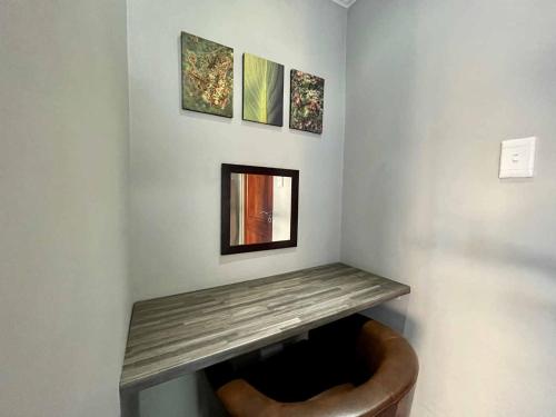 a corner of a room with a wooden shelf on a wall at ilanda Guest House in White River