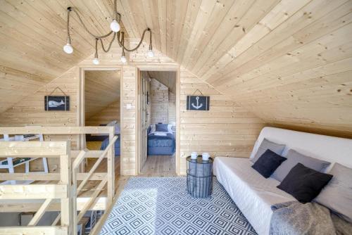 a small room with a bed and bunk beds at Dom nad Bychowianką in Białogóra