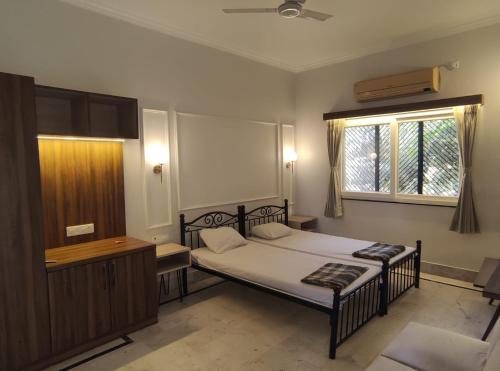 a bedroom with a bed and a window at Vatika Homestay in Varanasi