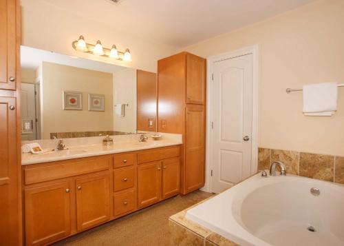 a bathroom with two sinks and a bath tub at Oasis at Orange Beach 1103 in Orange Beach