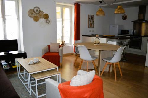uma cozinha e sala de estar com mesa e cadeiras em L'escapade - Logement les pieds dans l'eau à Luc em Luc-sur-Mer