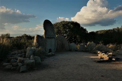 an old stone monument in a field with trees at Il Rifugio ad Orosei in Orosei