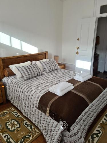 a bedroom with a large bed with pillows on it at Glaciar Guest House in Manteigas