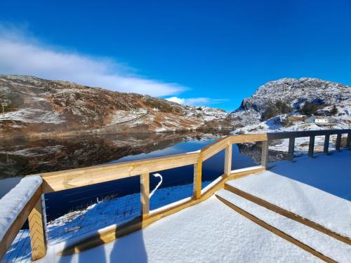 a bridge over a body of water with snow at NC500 - Modern croft house at Handa HI-00734-F in Scourie
