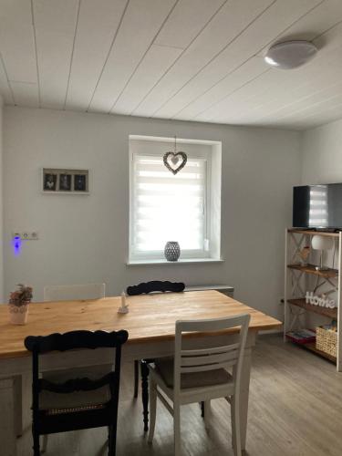 a dining room table with two chairs and a window at Ferienwohnung Petra in Rust