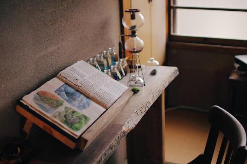 a table with a book and glasses on it at 神倉書斎 [Kamikura-Hideaway] in Shingu
