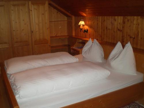 a bedroom with two beds with white pillows at "Kaiser Karl" *** Ferienwohnungen in Grossgmain