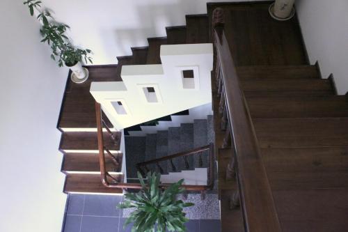 a staircase in a house with wooden floors at Green CoCo HomeStay in Hoi An