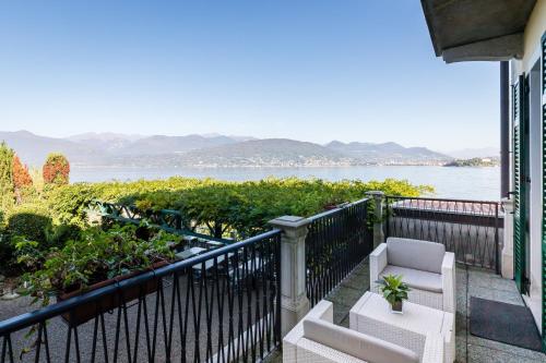 a balcony with a chair and a view of the water at Belvedere in Stresa
