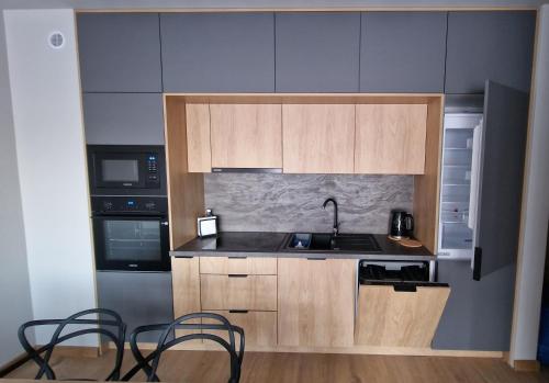 a small kitchen with a sink and a stove at Apartament SALONET Airport & MTP in Skórzewo
