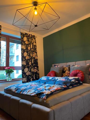 Bett in einem Zimmer mit einem großen Sofa in der Unterkunft APARTMENT SAUNA INFRARED 2 in Stettin