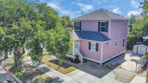 an overhead view of a pink house at Summer Bliss 3BR Home, Walk to Beach Master Suite Sleeps 9 in Galveston