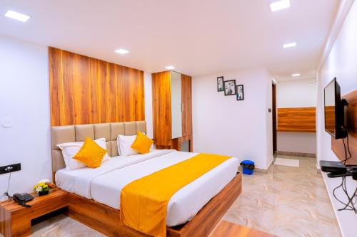 a bedroom with a large bed and a flat screen tv at CALANGUTE CASTLE in Bardez