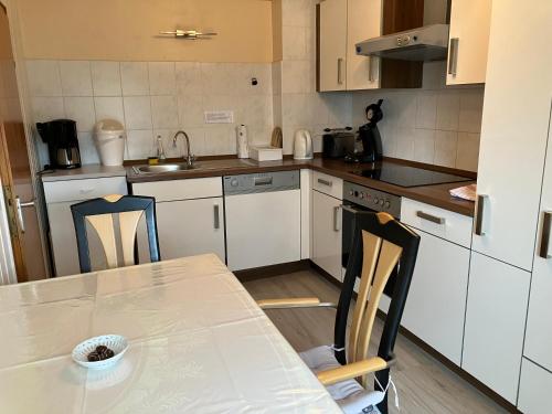 a kitchen with a table and chairs and a sink at Ferienwohnung im Grünen mit Balkon in Herdecke