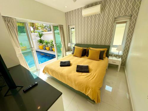 a bedroom with a bed with two towels on it at View Talay Villas, luxury private pool villa, 500m from Jomtien beach - 45 in Jomtien Beach