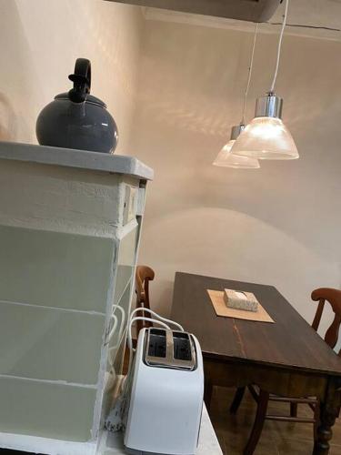 a kitchen with a table and a pot on the stove at Casa Selli in Monte Compatri