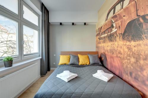 a bedroom with a bed with two pillows on it at Loft Apartment Haffnera Sopot by Grand Apartments in Sopot