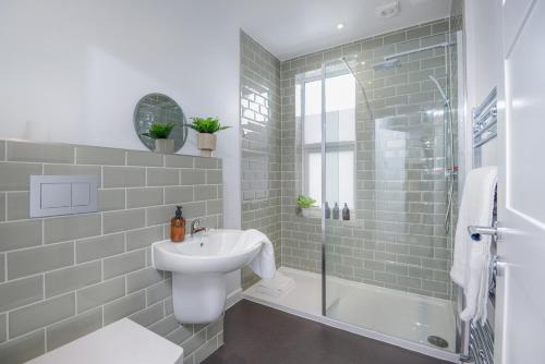 a white bathroom with a sink and a shower at Apartment Two - private car park, comfortable and well equipped - by Ocean City Retreats in Plymouth