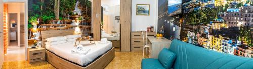 a bedroom with a bed and a blue couch at B&B-Apartment-Sleeps3-Parking-Balcony-PetFriendly in Sorrento
