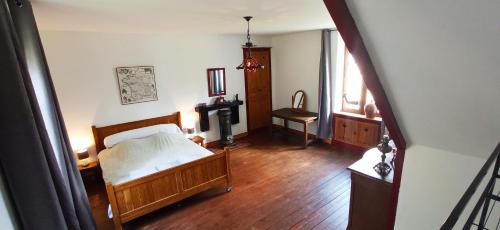 a bedroom with a bed and a television in it at Maison du Moulin Galuzot in Saint-Vallier